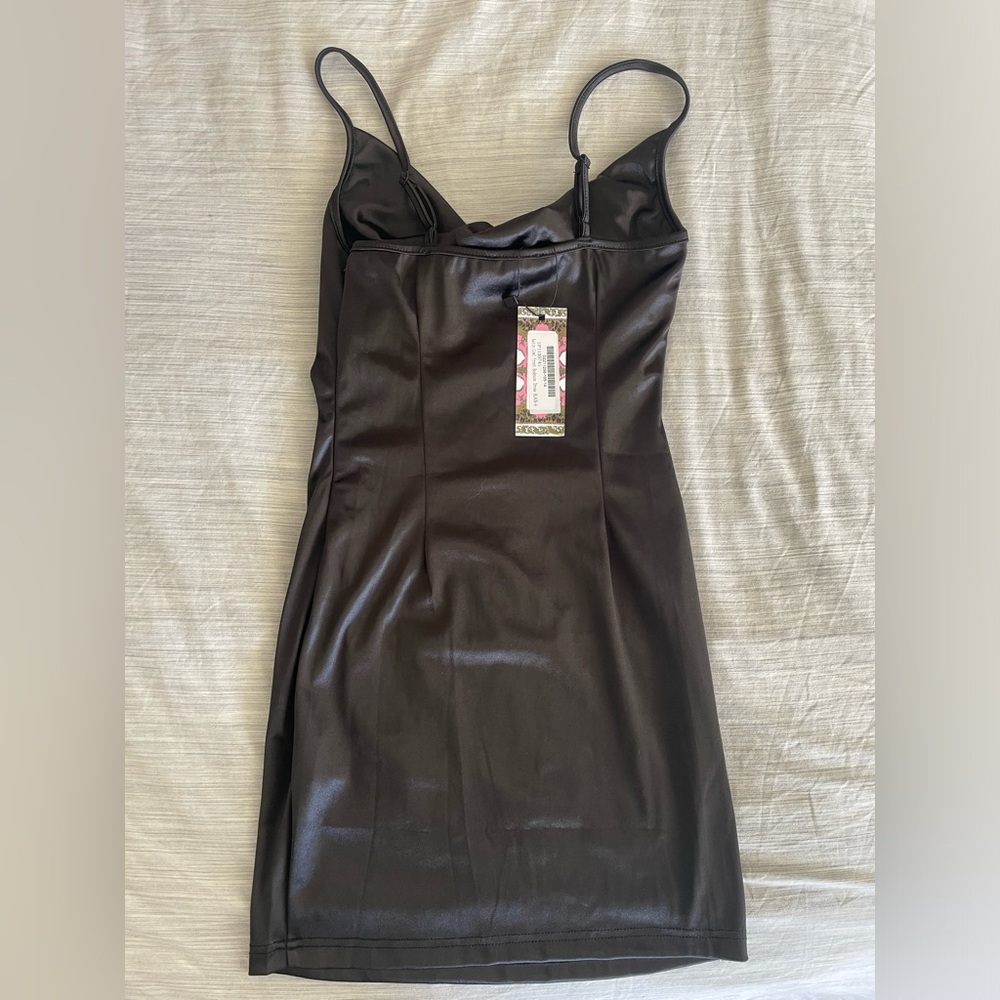 NWT and never worn before, Size M, Black form fitting satin material